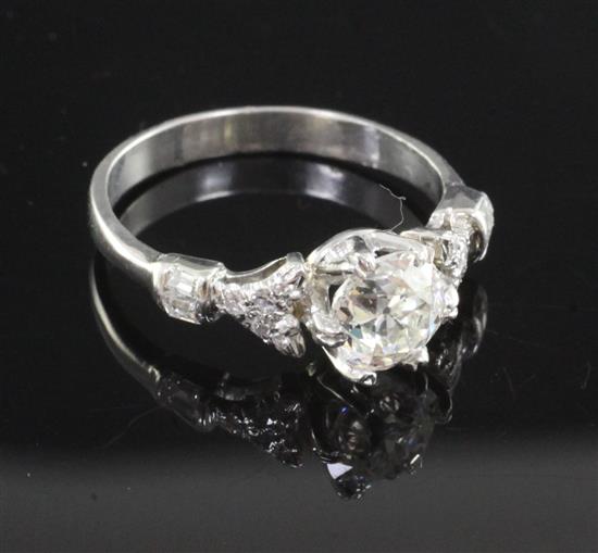 A white gold and single stone diamond ring with diamond set shoulders, size M.